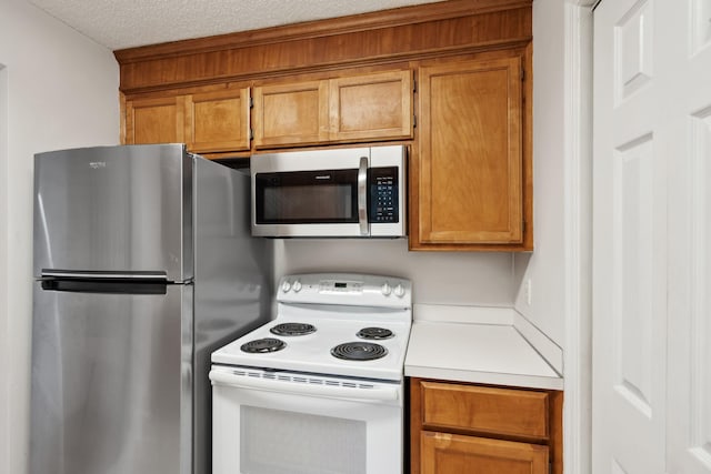 kitchen featuring stainless steel appliances and a textured ceiling