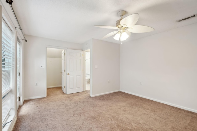 unfurnished bedroom with light colored carpet and ceiling fan