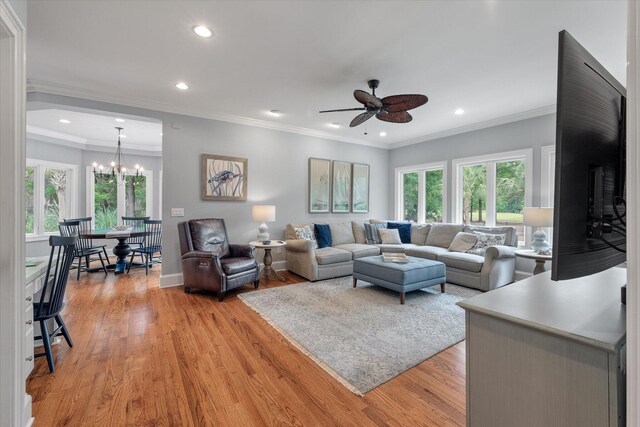 living room featuring a ceiling fan, light wood finished floors, recessed lighting, a chandelier, and baseboards