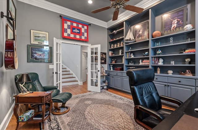 office area featuring french doors, light wood-type flooring, baseboards, crown molding, and ceiling fan