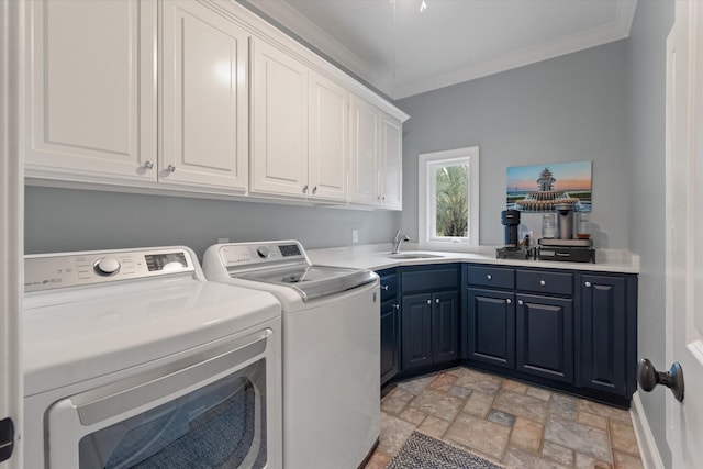 laundry room with washing machine and clothes dryer, cabinet space, ornamental molding, and stone finish flooring