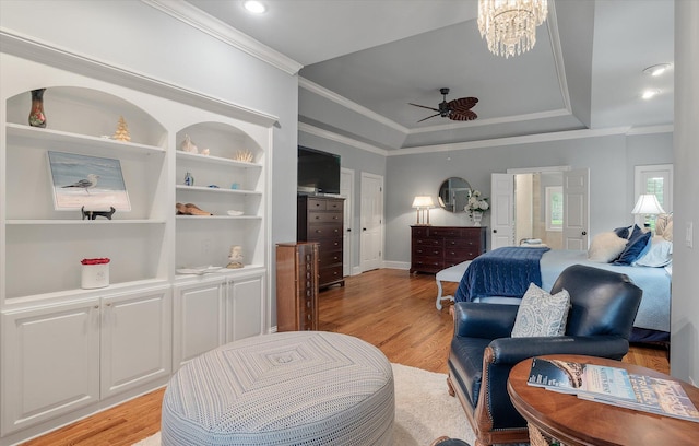 bedroom featuring crown molding, light wood-type flooring, a tray ceiling, and baseboards