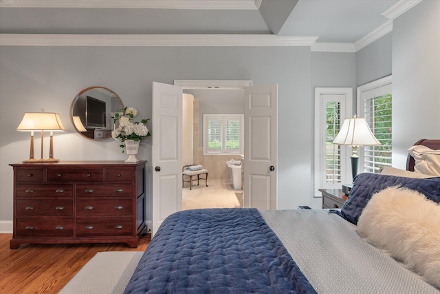 bedroom featuring ornamental molding, dark wood-type flooring, and baseboards