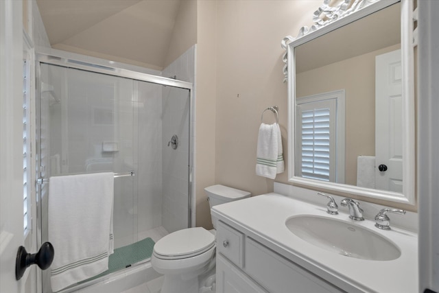 bathroom with a shower stall, toilet, and vanity