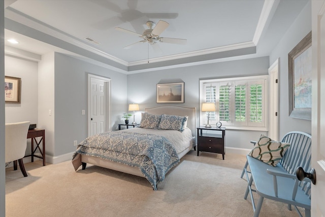 carpeted bedroom featuring a raised ceiling, baseboards, crown molding, and a ceiling fan