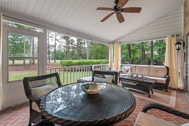 sunroom / solarium with ceiling fan, healthy amount of natural light, vaulted ceiling, and outdoor lounge area