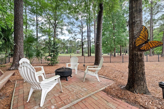 view of patio with a fire pit and fence