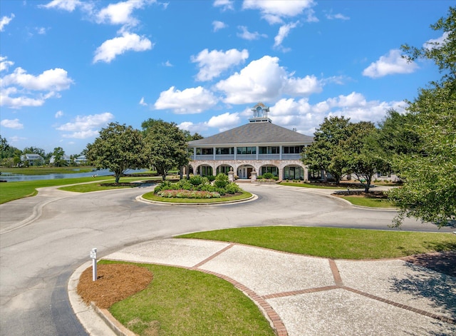 view of home's community featuring a water view and curved driveway
