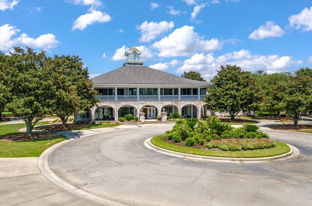 view of property featuring curved driveway