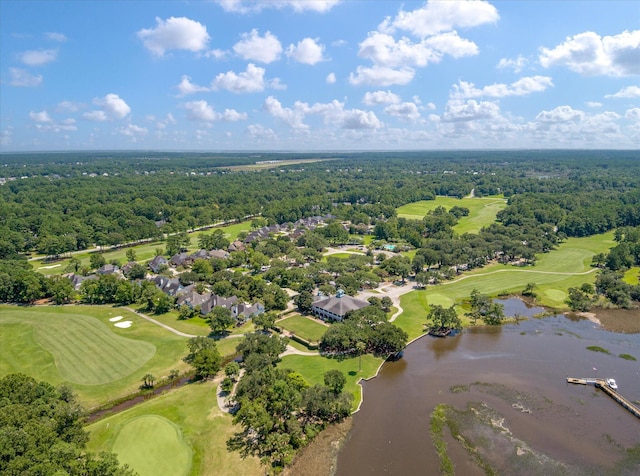 bird's eye view of a nearby body of water, a golf club, and a heavily wooded area