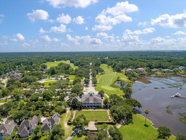drone / aerial view of a nearby body of water and a forest