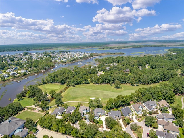 aerial view of property's location featuring a nearby body of water, nearby suburban area, and a golf course