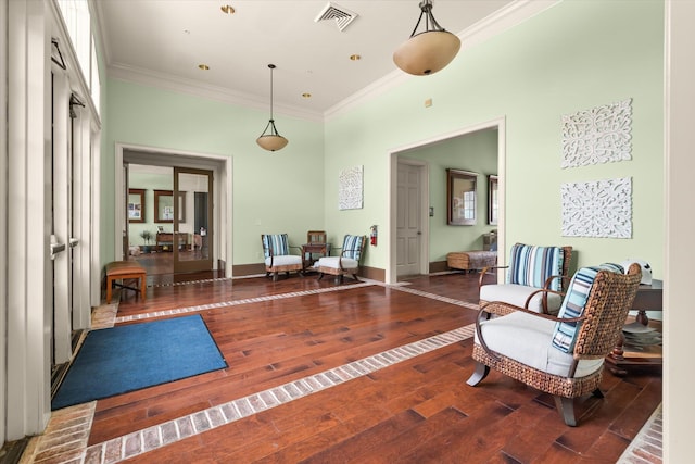 sitting room featuring crown molding and wood finished floors