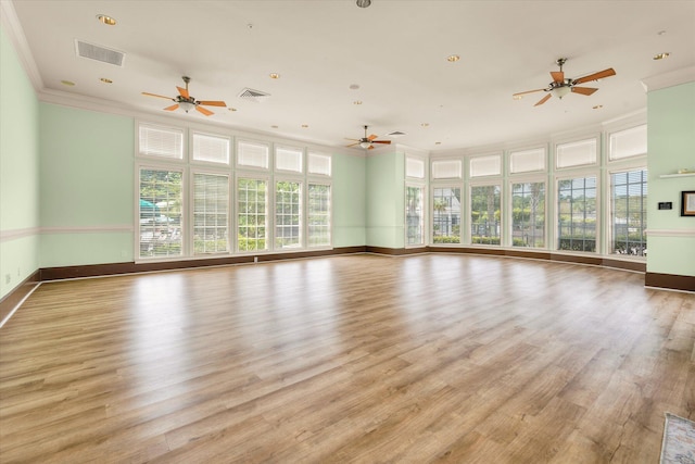 unfurnished living room featuring crown molding, baseboards, light wood-style flooring, a ceiling fan, and recessed lighting