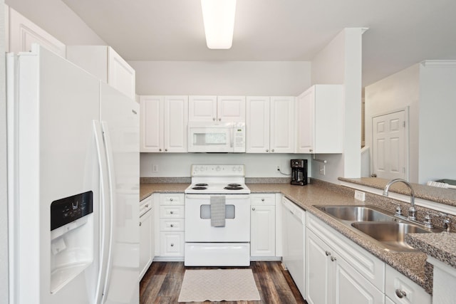 kitchen with dark hardwood / wood-style flooring, white cabinetry, sink, and white appliances