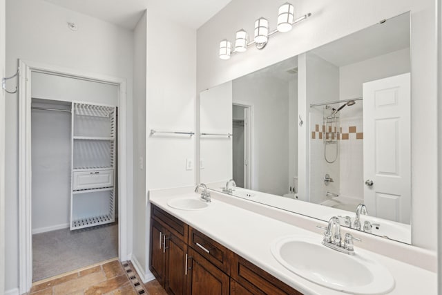 bathroom featuring vanity and tiled shower / bath