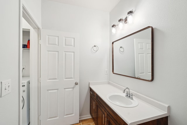 bathroom with washer / dryer and vanity