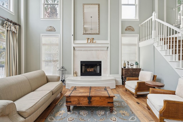 living room with hardwood / wood-style floors and a high ceiling