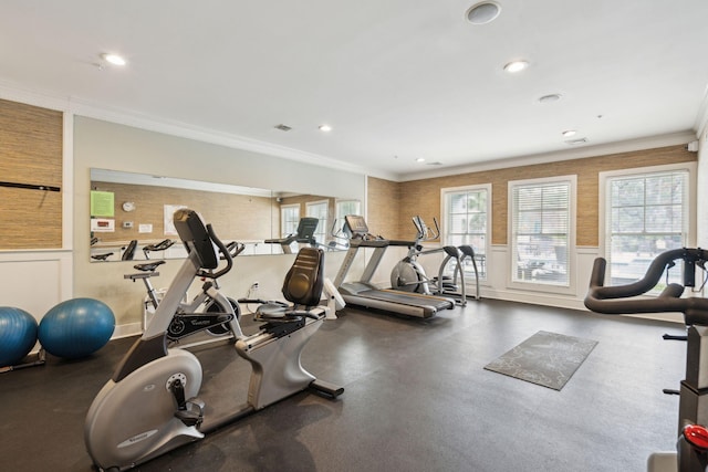 workout area featuring crown molding