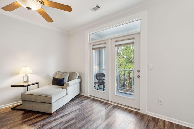 sitting room with dark hardwood / wood-style flooring, ceiling fan, and ornamental molding