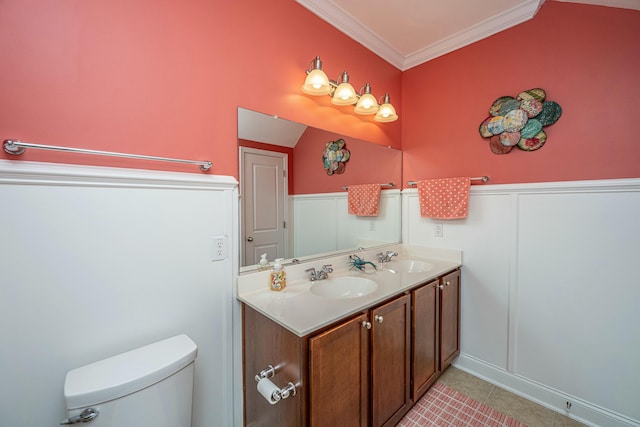 bathroom with tile patterned flooring, crown molding, vanity, and toilet