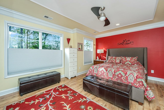 bedroom featuring ceiling fan, ornamental molding, and wood-type flooring