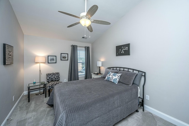 bedroom featuring vaulted ceiling, light colored carpet, and ceiling fan