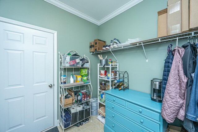 walk in closet with light tile patterned floors