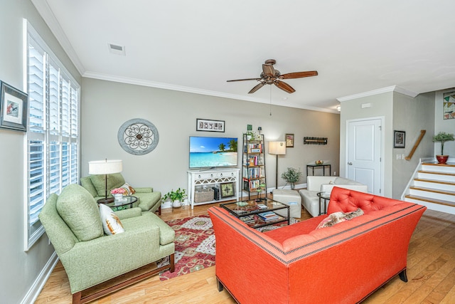 living room featuring crown molding, hardwood / wood-style floors, and ceiling fan