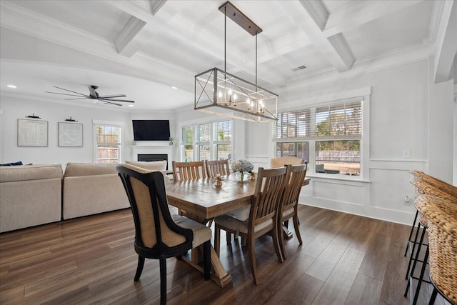 dining room with beam ceiling, coffered ceiling, and dark wood-style flooring