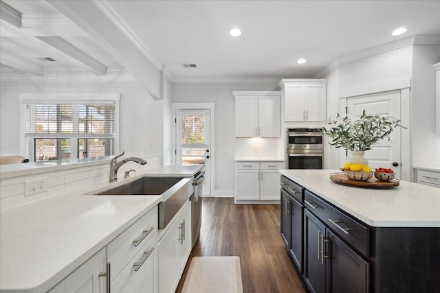 kitchen featuring light countertops, white cabinets, visible vents, and appliances with stainless steel finishes