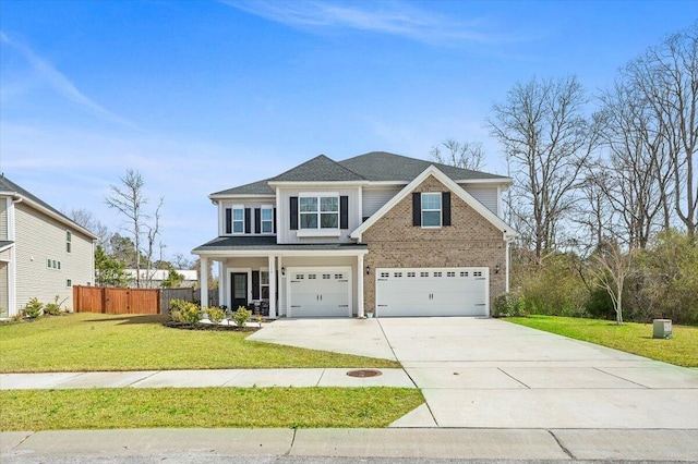 view of front of home with driveway, fence, a front yard, an attached garage, and brick siding