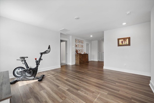 exercise room with visible vents, recessed lighting, baseboards, and wood finished floors