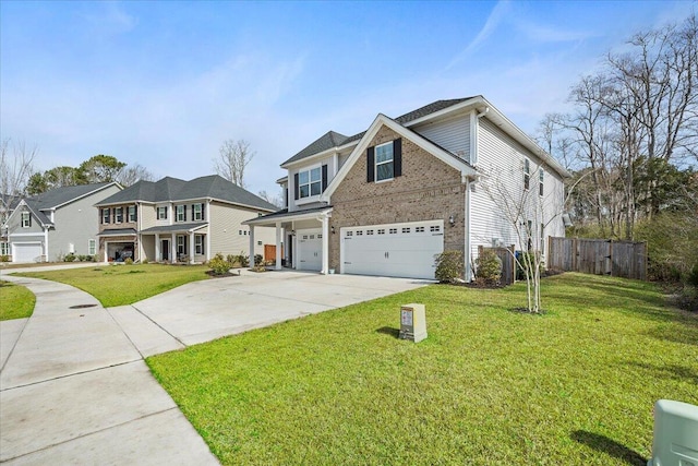 traditional-style home featuring fence, driveway, an attached garage, a front lawn, and brick siding