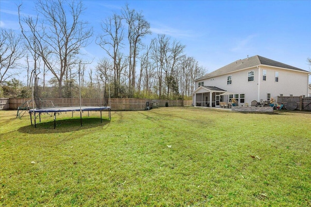 view of yard featuring a fenced backyard and a trampoline