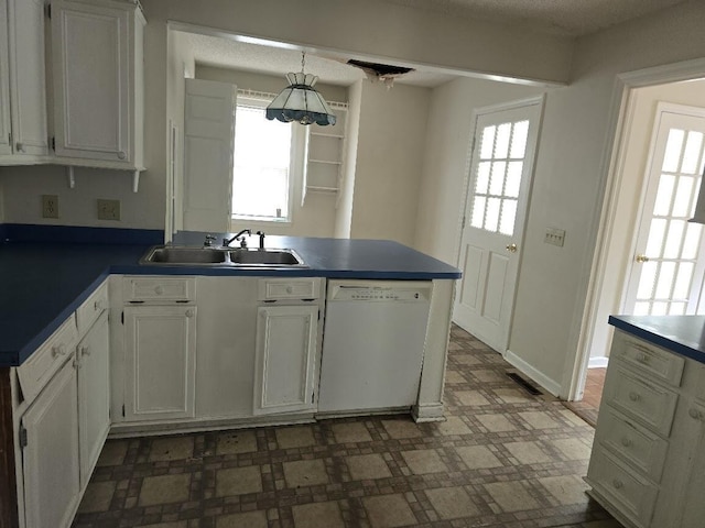 2858 Riley St, Orangeburg, SC 29118 - kitchen with white cabinets, a peninsula, tile patterned floors, a sink, and white dishwasher