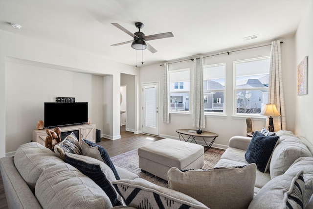 living room featuring wood-type flooring and ceiling fan