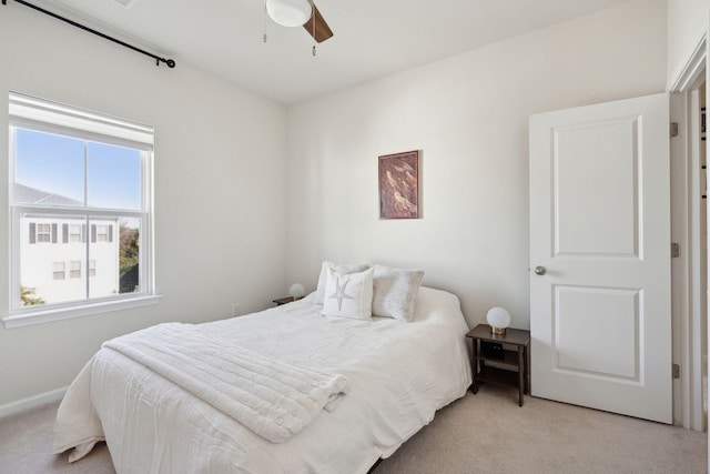 bedroom with ceiling fan and light colored carpet