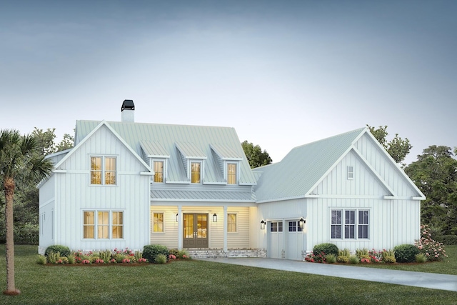 modern inspired farmhouse with a front lawn