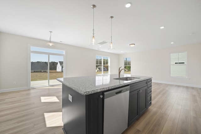 kitchen with a sink, open floor plan, light wood-type flooring, dishwasher, and a center island with sink