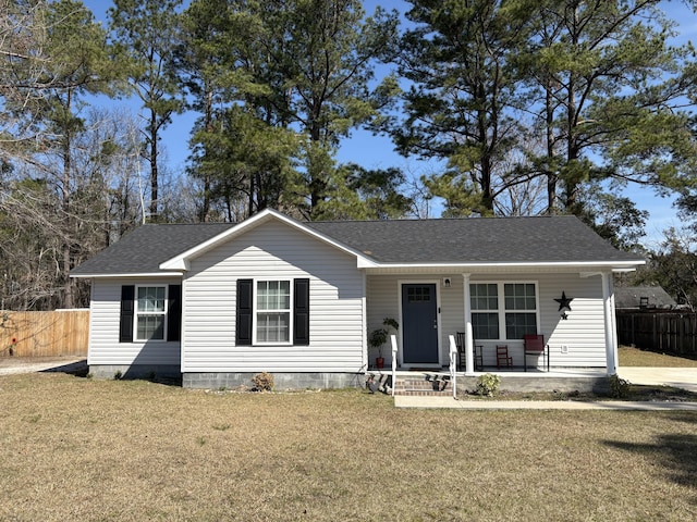 single story home with a shingled roof, a front yard, and fence