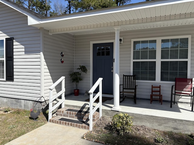 view of exterior entry with covered porch