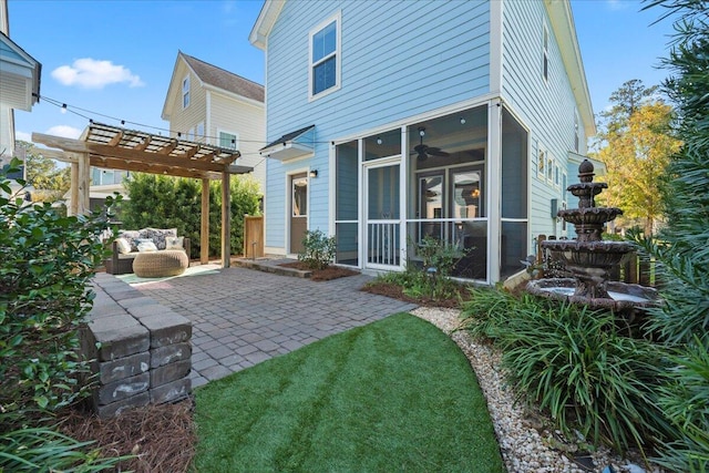 rear view of house with a patio, a pergola, and a sunroom