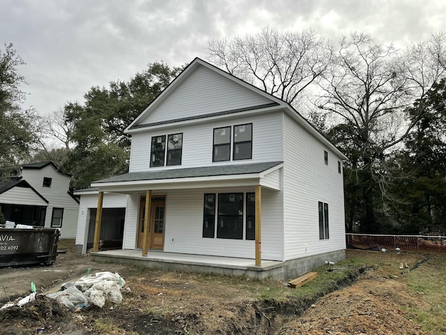 view of front of property featuring a porch and fence