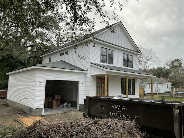 view of front facade featuring a porch and an attached garage