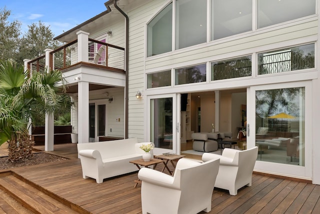 rear view of property featuring outdoor lounge area and a balcony