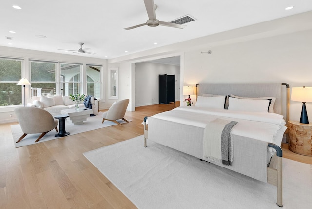 bedroom with light wood-style floors, recessed lighting, visible vents, and baseboards