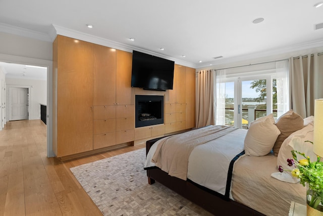 bedroom featuring crown molding, a fireplace, recessed lighting, visible vents, and light wood-style floors