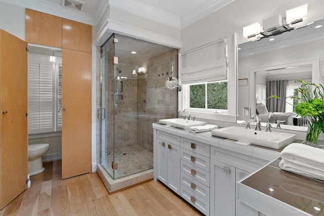 bathroom featuring ornamental molding, a sink, and a shower stall