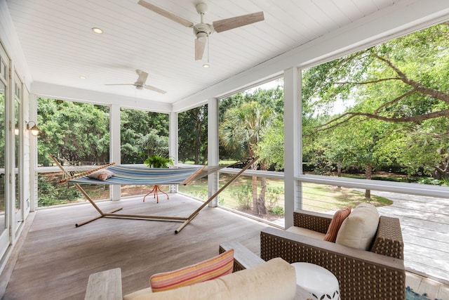 sunroom featuring ceiling fan